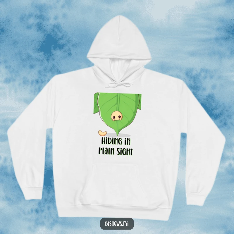 Funny hoodie with a cashew nut peeking from behind a large cashew leaf, offering a warm and whimsical sense of comfort.