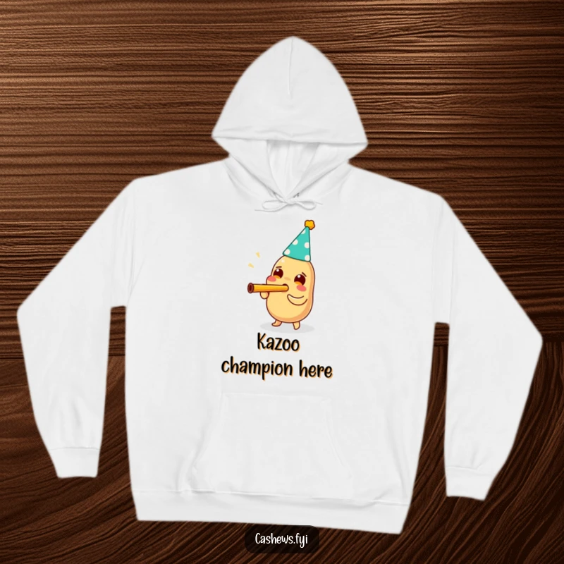 Funny hoodie with a cashew wearing a party hat and enthusiastically blowing a kazoo, radiating joy and festive cheer.