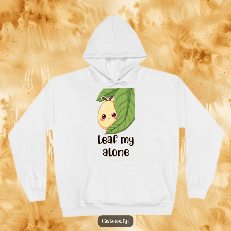 Funny Hoodie: A cashew with exaggerated googly eyes peeks from behind a large leaf, a soft and humorous sweatshirt for playful moments.
